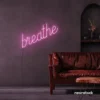 Breathe neon sign in baby pink for meditation rooms, yoga studios, and calming home decor.