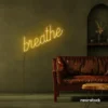 Breathe neon sign in golden yellow for meditation rooms, yoga studios, and calming home decor.