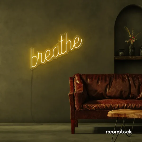 Breathe neon sign in golden yellow for meditation rooms, yoga studios, and calming home decor.