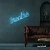 Breathe neon sign in ice blue for meditation rooms, yoga studios, and calming home decor.