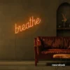 Breathe neon sign in orange for meditation rooms, yoga studios, and calming home decor.
