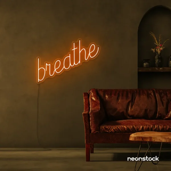Breathe neon sign in orange for meditation rooms, yoga studios, and calming home decor.