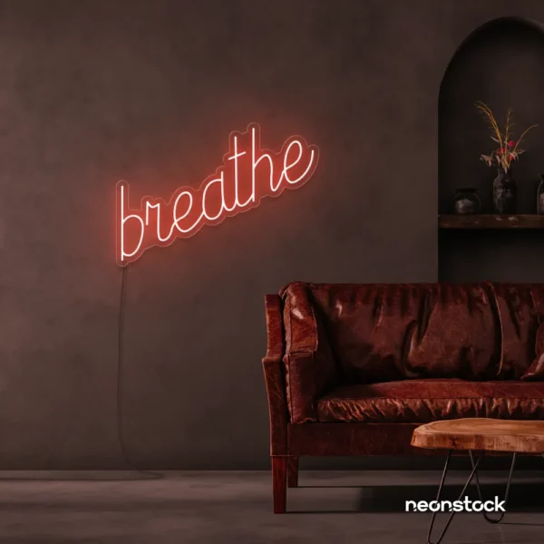 Breathe neon sign in peachy pink for meditation rooms, yoga studios, and calming home decor.