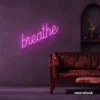 Breathe neon sign in pink for meditation rooms, yoga studios, and calming home decor.