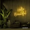 Hello Beautiful neon sign in golden yellow script font for salon styling walls and glam vanity decor.
