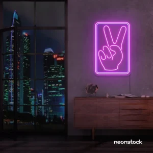 Purple neon peace hand sign mounted on a dark wall above a wooden cabinet.