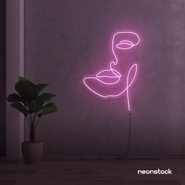 Abstract face neon sign in baby pink for beauty salons, nail studios, and spa wall decor.