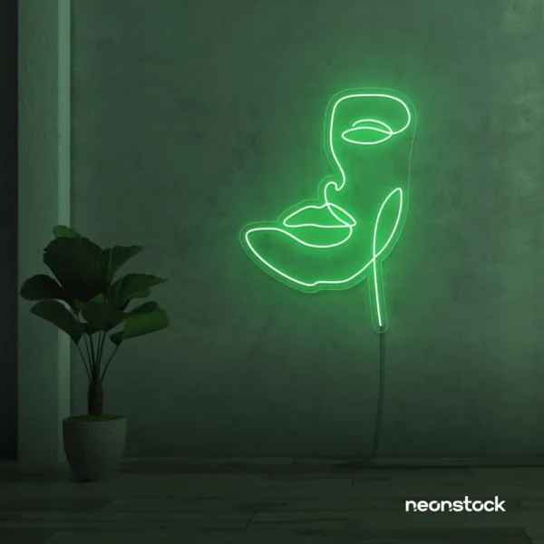 Abstract face neon sign in green for beauty salons, nail studios, and spa wall decor.