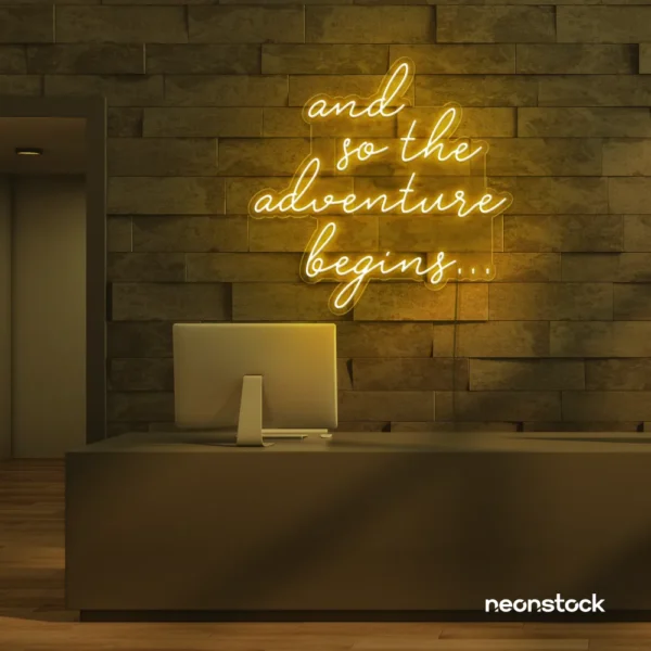 And So The Adventure Begins neon sign in golden yellow for wedding decor, new beginnings, and celebration walls.