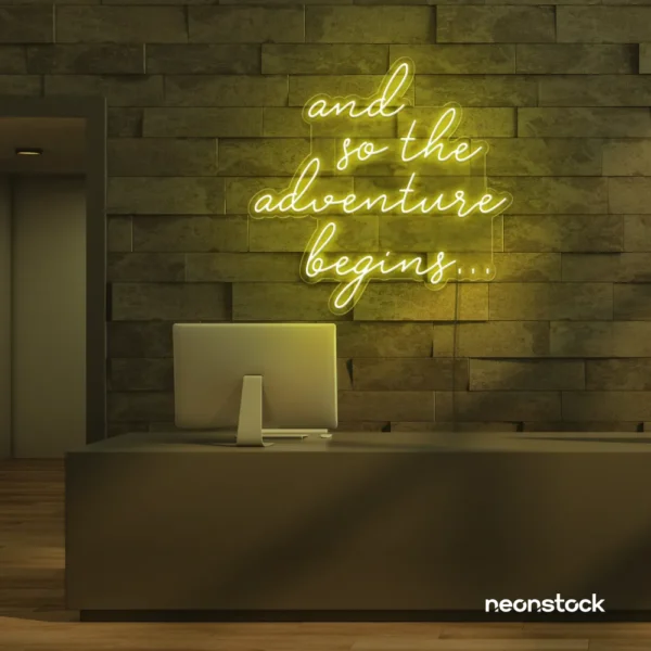 And So The Adventure Begins neon sign in lemon yellow for wedding decor, new beginnings, and celebration walls.