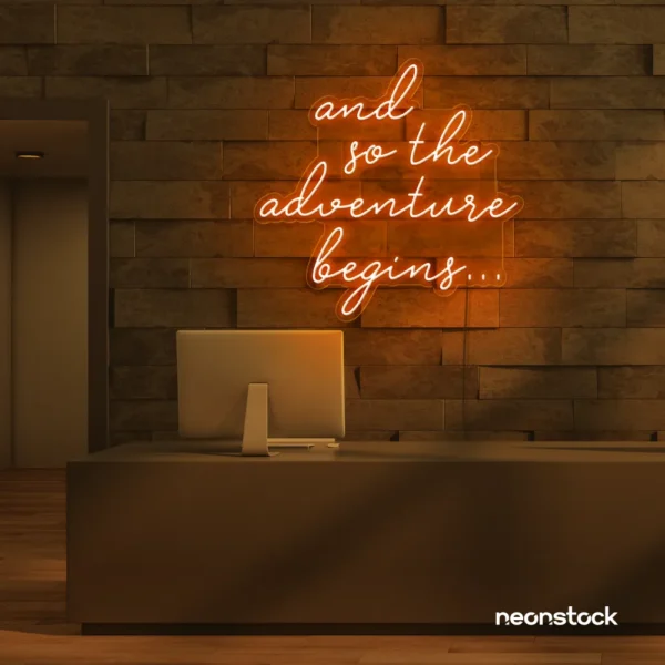 And So The Adventure Begins neon sign in orange for wedding decor, new beginnings, and celebration walls.