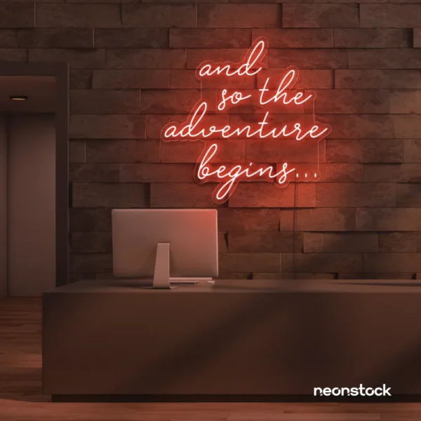 And So The Adventure Begins neon sign in peachy pink for wedding decor, new beginnings, and celebration walls.