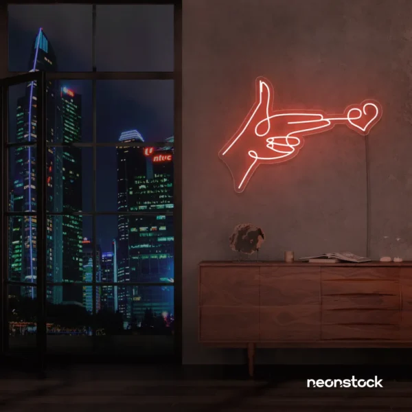 Hands shooting heart neon sign in peachy pink – romantic LED wall decor.