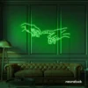 Hands neon sign in deep green – modern wall art symbolizing connection and emotion.