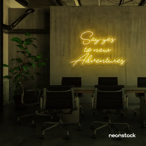 Say Yes to New Adventures neon sign in golden yellow for travel decor, modern entryways, and motivational vibes.