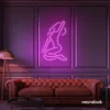 Sitting woman neon sign in pink for minimalist wall art and feminine home decor.