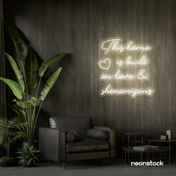 This Home Is Built on Love and Shenanigans neon sign in neutral white for family walls, living rooms, and cozy decor.