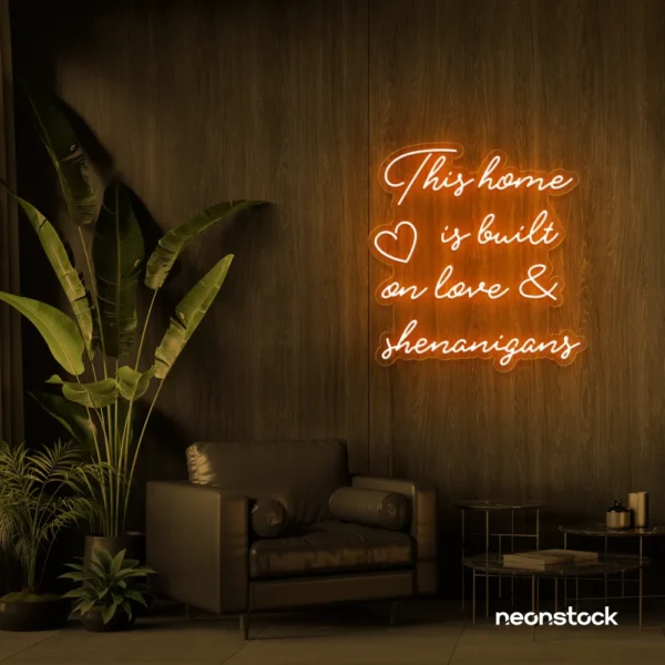 This Home Is Built on Love and Shenanigans neon sign in orange for family walls, living rooms, and cozy decor.