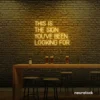 This Is The Sign You’ve Been Looking For neon sign in golden yellow for modern wall decor and motivational rooms.