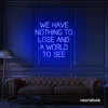 We Have Nothing to Lose and a World to See neon sign in dark blue for travel wall art and decor lovers.
