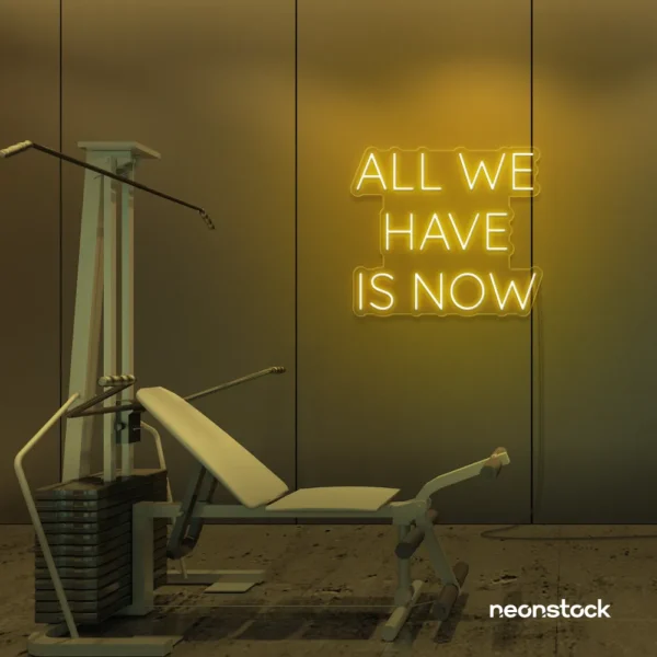 All We Have Is Now neon sign in golden yellow for modern wall decor, dorms, and cozy interiors.