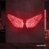 Elegant angel wings neon sign in red for wall art or restaurant decor.