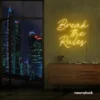 Break the Rules neon sign in golden yellow for rebellious decor, creative studios, and bold interiors.