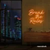Break the Rules neon sign in orange for rebellious decor, creative studios, and bold interiors.