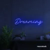 Dreaming neon sign in dark blue for dreamy decor, teen bedrooms, and relaxing nooks.