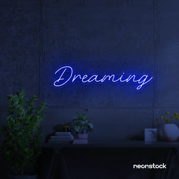 Dreaming neon sign in dark blue for dreamy decor, teen bedrooms, and relaxing nooks.