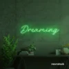Dreaming neon sign in green for dreamy decor, teen bedrooms, and relaxing nooks.