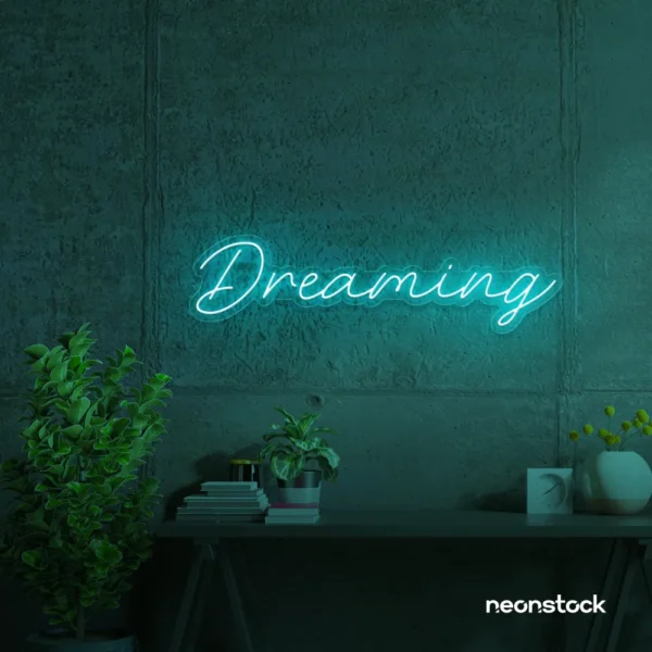 Dreaming neon sign in mint green for dreamy decor, teen bedrooms, and relaxing nooks.