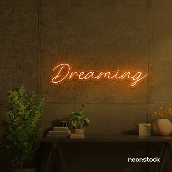 Dreaming neon sign in orange for dreamy decor, teen bedrooms, and relaxing nooks.