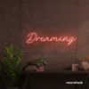 Dreaming neon sign in peachy pink for dreamy decor, teen bedrooms, and relaxing nooks.