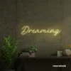 Dreaming neon sign in warm white for dreamy decor, teen bedrooms, and relaxing nooks.