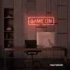 Game On neon sign in peachy pink for gaming setups, man caves, and kids' rooms.