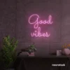 Good Vibes neon sign in baby pink for positive room decor, dorm walls, and relaxing interiors.