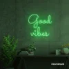 Good Vibes neon sign in green for positive room decor, dorm walls, and relaxing interiors.