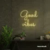 Good Vibes neon sign in warm white for positive room decor, dorm walls, and relaxing interiors.