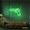 Gun neon sign in green – edgy LED wall decor for modern spaces and game rooms.