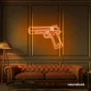 Gun neon sign in orange – edgy LED wall decor for modern spaces and game rooms.