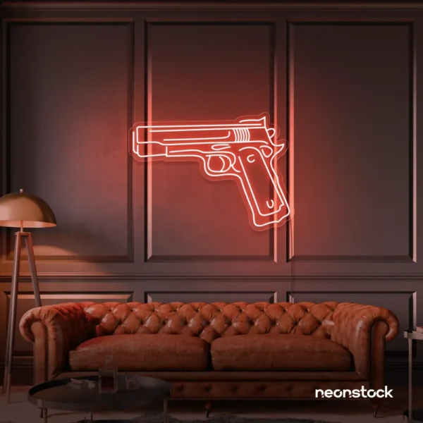 Gun neon sign in peachy pink – edgy LED wall decor for modern spaces and game rooms.