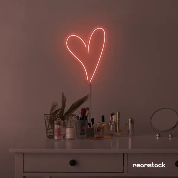 Heart neon sign in peachy pink for beauty salons, home decor, dorm rooms, and Valentine's Day themes.