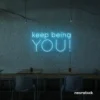 Keep Being You neon sign in ice blue for empowerment decor, teen rooms, and creative wall spaces.