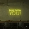 Keep Being You neon sign in lemon yellow for empowerment decor, teen rooms, and creative wall spaces.