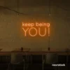 Keep Being You neon sign in orange for empowerment decor, teen rooms, and creative wall spaces.
