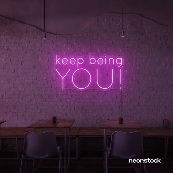 Keep Being You neon sign in pink for empowerment decor, teen rooms, and creative wall spaces.