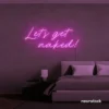 Let's Get Naked neon sign in pink for bathroom decor, cheeky bedrooms, and romantic lighting.