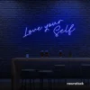 Love Yourself neon sign in dark blue for self-love decor, beauty rooms, and empowering spaces.