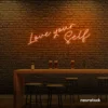 Love Yourself neon sign in peachy pink for self-love decor, beauty rooms, and empowering spaces.